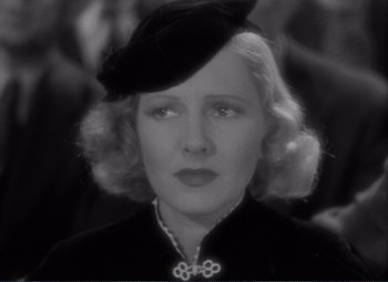 Movie still from “Mr. Deeds Goes to Town” (1936), directed by Frank Capra – An old photo of a woman wearing a black hat; Close Up shot, High angle