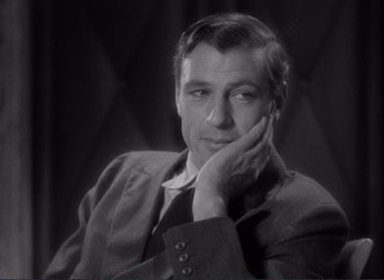 Movie still from “Mr. Deeds Goes to Town” (1936), directed by Frank Capra – An old photo of a man in a suit and tie; Close Up shot, Over the shoulder angle