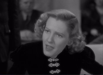 Movie still from “Mr. Deeds Goes to Town” (1936), directed by Frank Capra – An old photo of a woman in a black dress; Close Up shot, High angle