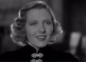 Movie still from “Mr. Deeds Goes to Town” (1936), directed by Frank Capra – An old photo of a woman in a black dress; Close Up shot, Over the shoulder angle