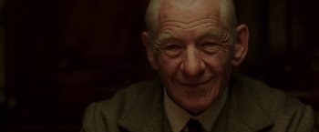 Movie still from “Mr. Holmes” (2015), directed by Bill Condon – An older man smiling for the camera; Close Up shot, Low angle