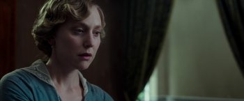 Movie still from “Mr. Holmes” (2015), directed by Bill Condon – A woman in a blue shirt is looking at the camera; Close Up shot, Over the shoulder angle