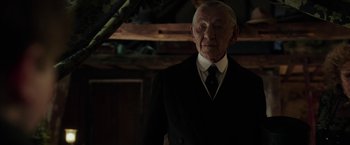 Movie still from “Mr. Holmes” (2015), directed by Bill Condon – An older man in a suit and tie; Medium shot, Low angle