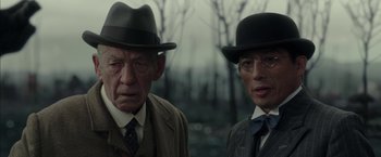 Movie still from “Mr. Holmes” (2015), directed by Bill Condon – Two men in suits and hats standing next to each other; Close Up shot, Low angle