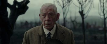 Movie still from “Mr. Holmes” (2015), directed by Bill Condon – An old man in a suit and tie holding a plate; Close Up shot, Low angle