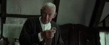Movie still from “Mr. Holmes” (2015), directed by Bill Condon – An older man holding a glass in his hand; Close Up shot, Low angle