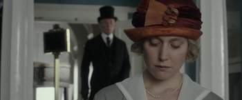 Movie still from “Mr. Holmes” (2015), directed by Bill Condon – A man and a woman wearing hats and a dress; Close Up shot, Over the shoulder angle