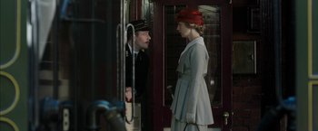 Movie still from “Mr. Holmes” (2015), directed by Bill Condon – A man and a woman standing next to each other in front of a door; Medium shot, Over the shoulder angle