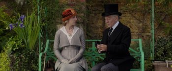 Movie still from “Mr. Holmes” (2015), directed by Bill Condon – An older man and a young woman sitting on a bench; Medium shot, Over the shoulder angle