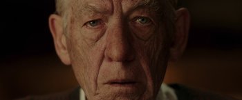 Movie still from “Mr. Holmes” (2015), directed by Bill Condon – An old man with a sad look on his face; Close Up shot, Low angle