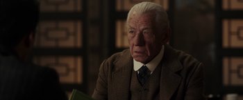 Movie still from “Mr. Holmes” (2015), directed by Bill Condon – An older man in a suit and tie looking sad; Close Up shot, Low angle