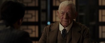 Movie still from “Mr. Holmes” (2015), directed by Bill Condon – An old man wearing a suit and a tie; Close Up shot, Over the shoulder angle