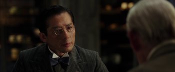 Movie still from “Mr. Holmes” (2015), directed by Bill Condon – An older man wearing a suit and bow tie; Close Up shot, Over the shoulder angle