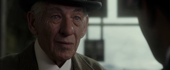 Movie still from “Mr. Holmes” (2015), directed by Bill Condon – An older man wearing a hat and a jacket; Close Up shot, Over the shoulder angle