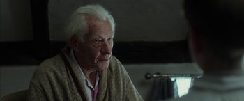 Movie still from “Mr. Holmes” (2015), directed by Bill Condon – An old man sitting in front of a mirror; Close Up shot, Over the shoulder angle