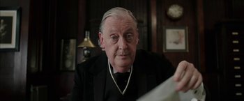 Movie still from “Mr. Holmes” (2015), directed by Bill Condon – An older man wearing a suit and tie; Close Up shot, Low angle