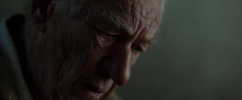 Movie still from “Mr. Holmes” (2015), directed by Bill Condon – An old man with a beard is looking down at his face; Close Up shot, Low angle