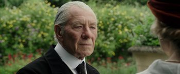 Movie still from “Mr. Holmes” (2015), directed by Bill Condon – An older man wearing a suit and tie; Close Up shot, Low angle