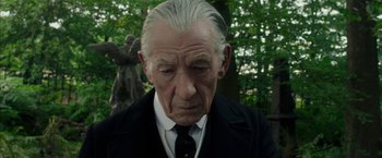 Movie still from “Mr. Holmes” (2015), directed by Bill Condon – An older man in a black suit and white shirt; Close Up shot, Low angle