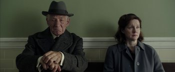 Movie still from “Mr. Holmes” (2015), directed by Bill Condon – An older man and a young woman sitting in a room; Close Up shot, Over the shoulder angle