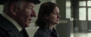 Movie still from “Mr. Holmes” (2015), directed by Bill Condon – A man and a woman looking at each other in front of a wall; Close Up shot, Over the shoulder angle