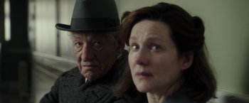 Movie still from “Mr. Holmes” (2015), directed by Bill Condon – An older man and a younger woman looking at the camera; Close Up shot, Over the shoulder angle