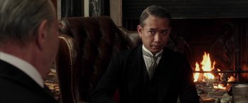 Movie still from “Mr. Holmes” (2015), directed by Bill Condon – A man in a suit sitting in a chair; Close Up shot, Low angle