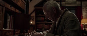 Movie still from “Mr. Holmes” (2015), directed by Bill Condon – An older man writing on a piece of paper; Close Up shot, Low angle
