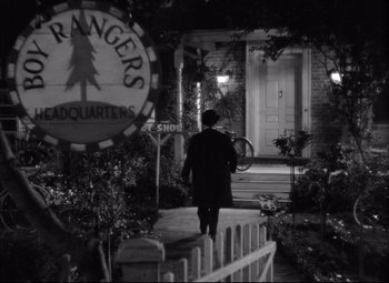 Movie still from “Mr. Smith Goes to Washington” (1939), directed by Frank Capra – A man walking down a sidewalk in front of a building; Extreme Wide shot, Low angle