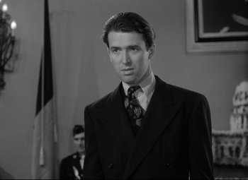 Movie still from “Mr. Smith Goes to Washington” (1939), directed by Frank Capra – A black and white photo of a man in a suit and tie; Close Up shot, Low angle