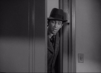 Movie still from “Mr. Smith Goes to Washington” (1939), directed by Frank Capra – A black and white photo of a man in a suit and a hat; Medium shot, Over the shoulder angle