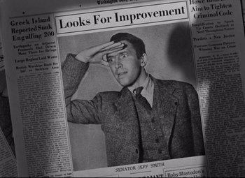 Movie still from “Mr. Smith Goes to Washington” (1939), directed by Frank Capra – A man saluting in front of a newspaper article; Close Up shot, Overhead angle
