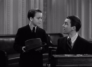 Movie still from “Mr. Smith Goes to Washington” (1939), directed by Frank Capra – A man and a young boy in suits and ties; Medium shot, Over the shoulder angle
