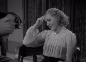 Movie still from “Mr. Smith Goes to Washington” (1939), directed by Frank Capra – A black and white photo of a woman sitting in a chair; Close Up shot, High angle