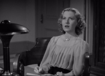 Movie still from “Mr. Smith Goes to Washington” (1939), directed by Frank Capra – A black and white photo of a woman sitting in a chair; Close Up shot, High angle