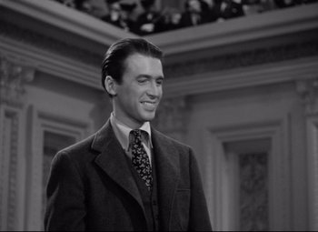 Movie still from “Mr. Smith Goes to Washington” (1939), directed by Frank Capra – A black and white photo of a man in a suit and tie; Medium shot, Low angle