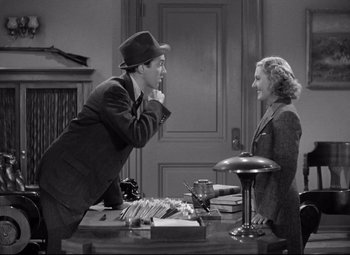 Movie still from “Mr. Smith Goes to Washington” (1939), directed by Frank Capra – A man and a woman sitting at a table; Medium shot, High angle