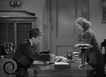 Movie still from “Mr. Smith Goes to Washington” (1939), directed by Frank Capra – A man and a woman sitting at a table; Medium shot, High angle