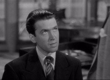 Movie still from “Mr. Smith Goes to Washington” (1939), directed by Frank Capra – A black and white photo of a man in a suit and tie; Close Up shot, High angle