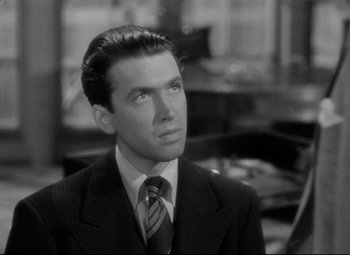 Movie still from “Mr. Smith Goes to Washington” (1939), directed by Frank Capra – A black and white photo of a man wearing a suit and tie; Close Up shot, High angle