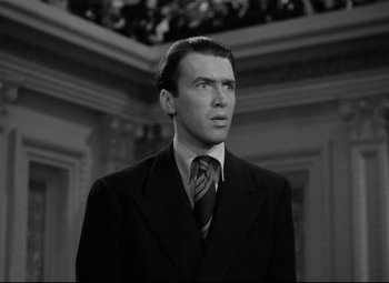 Movie still from “Mr. Smith Goes to Washington” (1939), directed by Frank Capra – A black and white photo of a man in a suit and tie; Close Up shot, Low angle