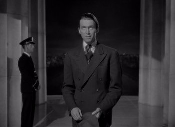 Movie still from “Mr. Smith Goes to Washington” (1939), directed by Frank Capra – A black and white photo of a man in a suit and tie; Medium shot, Low angle