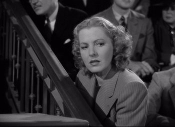 Movie still from “Mr. Smith Goes to Washington” (1939), directed by Frank Capra – A woman in a suit sitting in front of other people; Close Up shot, Low angle