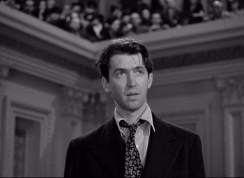 Movie still from “Mr. Smith Goes to Washington” (1939), directed by Frank Capra – A black and white photo of a man wearing a suit and tie; Close Up shot, Over the shoulder angle