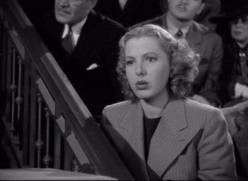 Movie still from “Mr. Smith Goes to Washington” (1939), directed by Frank Capra – A black and white photo of a woman in a suit; Close Up shot, High angle