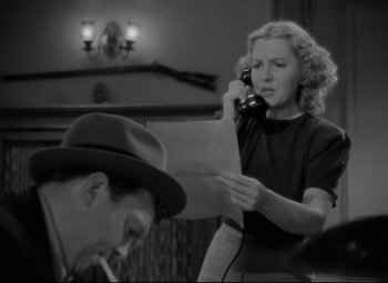 Movie still from “Mr. Smith Goes to Washington” (1939), directed by Frank Capra – An old photo of a woman on the phone and a man in a hat; Medium shot, Low angle