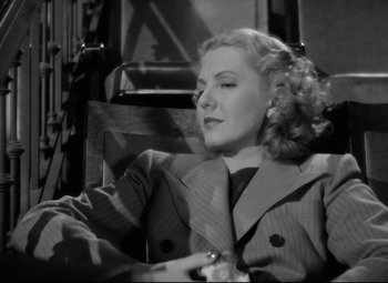 Movie still from “Mr. Smith Goes to Washington” (1939), directed by Frank Capra – A black and white photo of a woman sitting in a chair; Close Up shot, Low angle