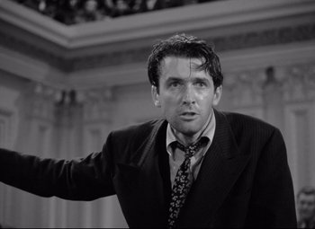 Movie still from “Mr. Smith Goes to Washington” (1939), directed by Frank Capra – Black and white photograph of a man wearing a suit and tie; Close Up shot, Low angle