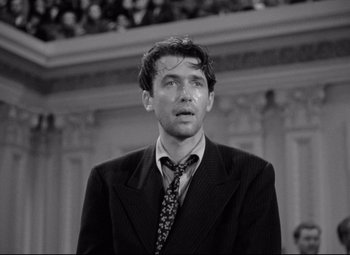 Movie still from “Mr. Smith Goes to Washington” (1939), directed by Frank Capra – Black and white photograph of a man wearing a suit and tie; Close Up shot, Low angle