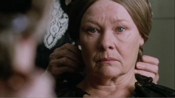 Movie still from “Mrs. Brown” (1997), directed by John Madden – An older woman looking at the camera with a concerned look on her face; Close Up shot, Over the shoulder angle